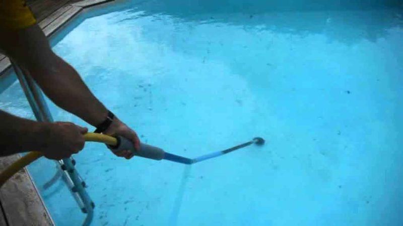 cleaning the bottom of the pool